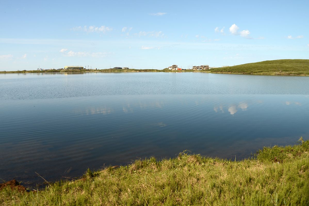 24A Buildings And Clouds Reflected In The Water At Tuktoyaktuk Northwest Territories